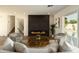 Bright living room boasting a fireplace, hardwood floors, and stylish decor, creating a welcoming and elegant space at 3413 N 87Th Pl, Scottsdale, AZ 85251