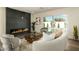 Cozy living room featuring a sleek fireplace, comfortable seating, and a view of the sparkling pool outside at 3413 N 87Th Pl, Scottsdale, AZ 85251