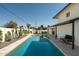 Beautiful backyard pool with travertine pavers, lounge chairs, and lush landscaping at 3413 N 87Th Pl, Scottsdale, AZ 85251