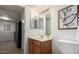 Bathroom with double mirrors, wood cabinet vanity, and toilet at 3511 E Baseline Rd # 1235, Phoenix, AZ 85042