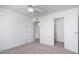 A bright bedroom with a ceiling fan and closet, offering comfort and functionality in a neutral color scheme at 3511 E Baseline Rd # 1235, Phoenix, AZ 85042