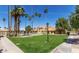 Exterior view of community pool, townhomes and lush green landscape, a beautiful setting for relaxation and recreation at 3511 E Baseline Rd # 1235, Phoenix, AZ 85042