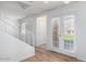 View of the living room with wood floors, a staircase, and double doors to the outside at 3511 E Baseline Rd # 1235, Phoenix, AZ 85042