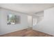 Open-concept living area with wood floors, window, and staircase at 3511 E Baseline Rd # 1235, Phoenix, AZ 85042