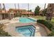 Exterior shot of pool and hot tub, surrounded by landscaped grounds and multi-story condo complex in the background at 3511 E Baseline Rd # 1235, Phoenix, AZ 85042