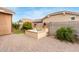 Inviting backyard oasis with charming fountain, mature landscaping, and hardscape pavers for outdoor enjoyment at 3637 E Ebano St, Gilbert, AZ 85295