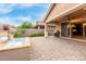 Charming backyard features water feature, green landscaping, pavers, and a seamless transition to covered patio at 3637 E Ebano St, Gilbert, AZ 85295