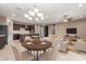 Elegant living room with dark cabinetry, stainless steel appliances, recessed lighting, and open floorplan at 3637 E Ebano St, Gilbert, AZ 85295