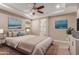 The primary bedroom has neutral-toned walls and carpeting, ceiling fan, ensuite bathroom, and recessed lighting at 3637 E Ebano St, Gilbert, AZ 85295