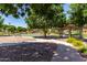 Community park with walking paths, benches, mature trees, and play areas at 3637 E Ebano St, Gilbert, AZ 85295