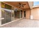 Covered patio features neutral colors, ceiling fan, and pavers for outdoor enjoyment and easy access to the home at 3637 E Ebano St, Gilbert, AZ 85295