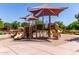 Community playground featuring covered play structures on a sand base with surrounding landscaping at 3637 E Ebano St, Gilbert, AZ 85295