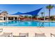 Community pool with blue awning, lounge chairs, and well-maintained pool area at 3637 E Ebano St, Gilbert, AZ 85295
