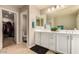 Light-filled bathroom showcasing double vanity, walk-in closet, and separate toilet area at 3914 S 58Th Ln, Phoenix, AZ 85043