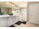 Bathroom with dual sinks, white cabinetry, and a glass shower with modern tile at 3914 S 58Th Ln, Phoenix, AZ 85043