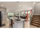 Open concept kitchen featuring granite island, appliances, and dining and living spaces at 3914 S 58Th Ln, Phoenix, AZ 85043
