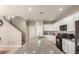 Open kitchen featuring granite counters, white cabinets, and modern appliances at 3914 S 58Th Ln, Phoenix, AZ 85043