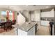 Spacious kitchen with granite island counter, sink, and eat-in dining area at 3914 S 58Th Ln, Phoenix, AZ 85043