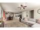 Well-lit living area with dining area, ceiling fan, and view into kitchen at 3914 S 58Th Ln, Phoenix, AZ 85043