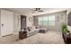 Comfortable living room featuring a ceiling fan, large window, and neutral decor at 3914 S 58Th Ln, Phoenix, AZ 85043