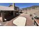 Expansive backyard with a tiled patio, outdoor kitchen, and desert landscape, perfect for Arizona living at 4016 E Western Star Blvd, Phoenix, AZ 85044