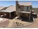 Image shows the backyard of the property with a second story balcony, spiral staircase and gravel landscaping at 4016 E Western Star Blvd, Phoenix, AZ 85044