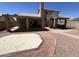 Spacious backyard featuring a tile patio, spiral staircase to an upper balcony, and beautiful landscaping at 4016 E Western Star Blvd, Phoenix, AZ 85044