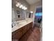 Bathroom with a double sink vanity, light wood cabinetry, and tile flooring, providing ample space at 4016 E Western Star Blvd, Phoenix, AZ 85044