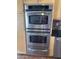 Stainless steel GE Profile double oven with light wood cabinetry at 4016 E Western Star Blvd, Phoenix, AZ 85044