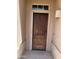 Covered front door with dark wood finish, transom window, and traditional hardware at 4016 E Western Star Blvd, Phoenix, AZ 85044