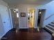 Bright hallway with hardwood floors, featuring several doorways leading to various rooms within the home at 4016 E Western Star Blvd, Phoenix, AZ 85044
