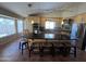 Bright and airy kitchen with black countertops, wood cabinets, stainless steel appliances, and barstool seating at 4016 E Western Star Blvd, Phoenix, AZ 85044