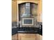 Modern kitchen featuring stainless steel appliances, custom tile backsplash, and granite countertops at 4016 E Western Star Blvd, Phoenix, AZ 85044
