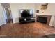 Living room featuring a tile floor, a fireplace, and an entertainment center at 4016 E Western Star Blvd, Phoenix, AZ 85044