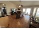 Open living room with tile flooring, a cozy fireplace, TV, and glass sliding doors to the backyard at 4016 E Western Star Blvd, Phoenix, AZ 85044