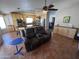 Cozy living room featuring a plush recliner and open floor plan with a view into the bright kitchen at 4016 E Western Star Blvd, Phoenix, AZ 85044