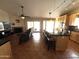 Spacious living room featuring a kitchen bar, tile flooring, and a cozy fireplace at 4016 E Western Star Blvd, Phoenix, AZ 85044
