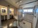 Main bathroom with dual sinks, a soaking tub, and a walk-in shower with decorative tile at 4016 E Western Star Blvd, Phoenix, AZ 85044