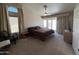 A primary bedroom with neutral colors and an exterior door with a view, along with a ceiling fan at 4016 E Western Star Blvd, Phoenix, AZ 85044