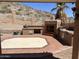 Covered outdoor kitchen with brick flooring, stainless steel appliances, and fireplace with desert view at 4016 E Western Star Blvd, Phoenix, AZ 85044