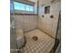 Walk-in shower features decorative tile and a window for natural light at 4016 E Western Star Blvd, Phoenix, AZ 85044