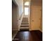 Carpeted stairway with a wooden handrail, leading to the upper level of the home with natural light from the window at 4016 E Western Star Blvd, Phoenix, AZ 85044