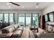 Bright living room featuring a large leather couch, hardwood floors, and sliding glass doors to the backyard at 4044 E Dawson E Dr, Chandler, AZ 85249