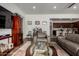 Inviting living room with hardwood floors, a leather couch, and a view into the open-concept kitchen at 4044 E Dawson E Dr, Chandler, AZ 85249