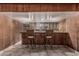 Bar with wood paneling, mirror backsplash, and seating for two at 4144 N 29Th Ave, Phoenix, AZ 85017