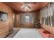 Bedroom featuring wood paneled walls, a window with curtains, and carpet, creating a simple space at 4144 N 29Th Ave, Phoenix, AZ 85017