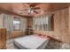 Bedroom showcasing wood paneled walls, a window with curtains, and carpet, creating a simple space at 4144 N 29Th Ave, Phoenix, AZ 85017