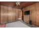 Bedroom featuring wood paneled walls, a window with curtains, and carpet, creating a simple space at 4144 N 29Th Ave, Phoenix, AZ 85017