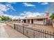 Single-story home with neutral gravel yard and brick fire pit offers a relaxed outdoor living space at 4144 N 29Th Ave, Phoenix, AZ 85017