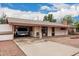 Single-story house with a long driveway leading to an open carport; front entrance has a small dog house at 4144 N 29Th Ave, Phoenix, AZ 85017